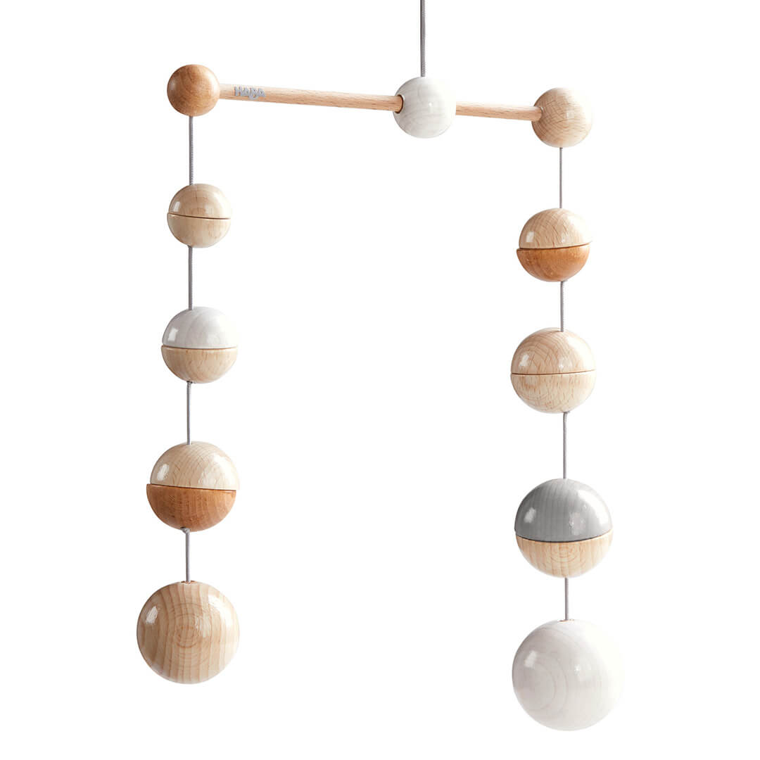 Wooden Mobile Dots hanging mobile made of wooden spheres in various natural and painted finishes, suspended by a slender rod.