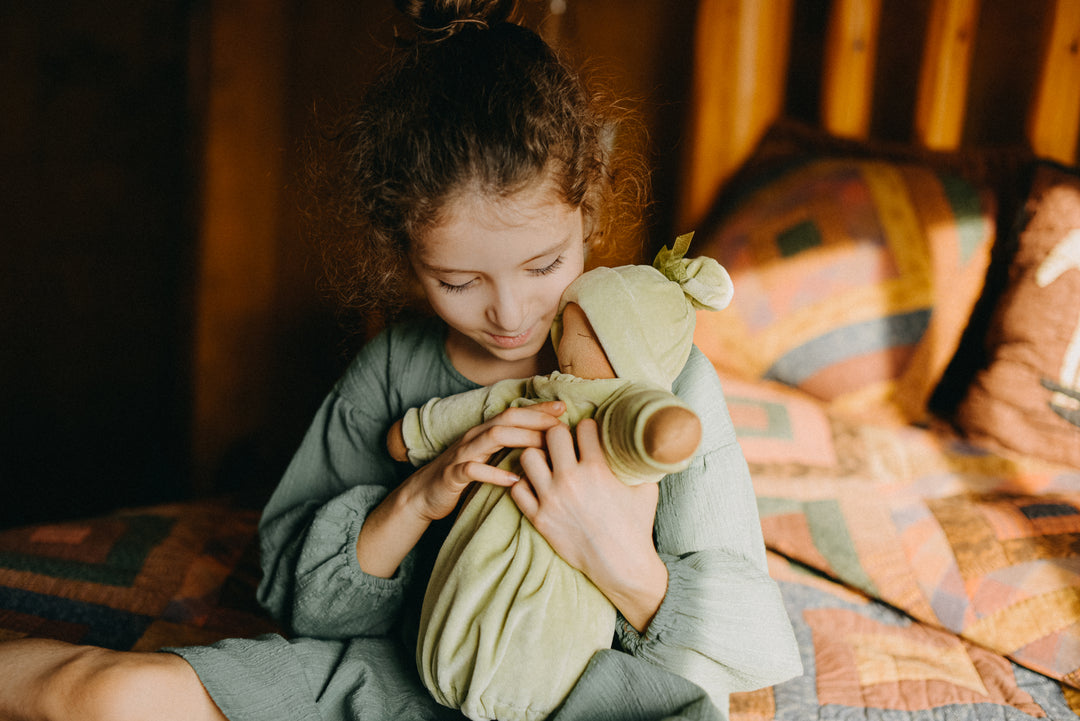 Nourishing to the Senses:  | Image of child holding a simple Waldorf Doll