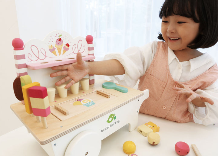 Girl playing with Tender Leaf Toys Wooden Ice Cream Cart Play Set - Bella Luna Toys