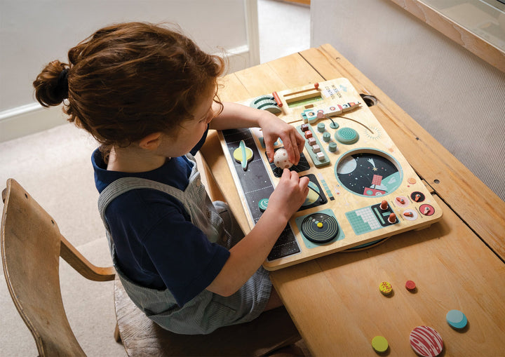 Girl playing with Tender Leaf Toys - Wooden Space Station