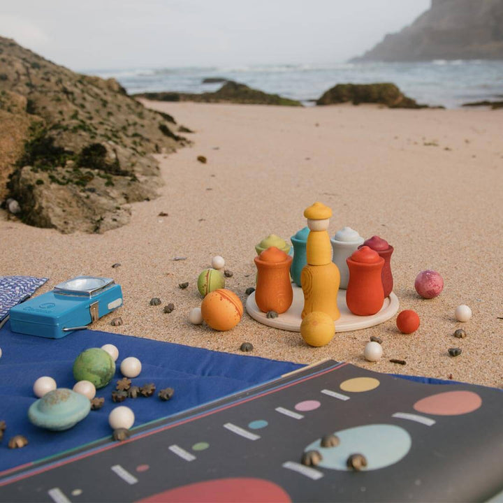 Grapat Dear Universe wooden ball set on beach with the sea