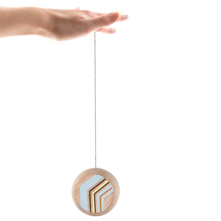 Hand holding extended wooden yoyo