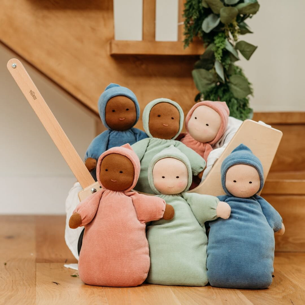 6 Bella Luna Toys Waldorf Dolls in different colors inside a wooden HABA pram.