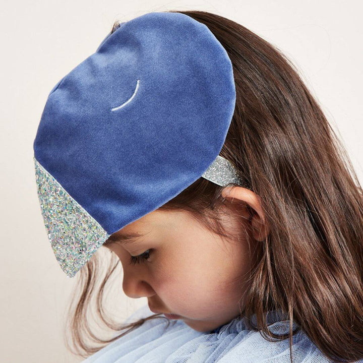 A child wearing the head piece for the Blue Velvet Bird Costume.