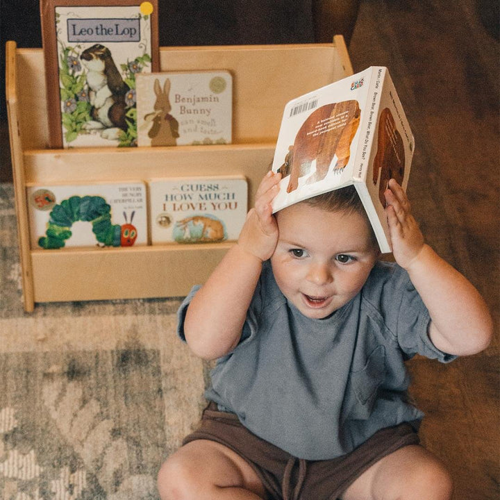 Book Nook Wooden Book Shelf on floor with kid and book on his head