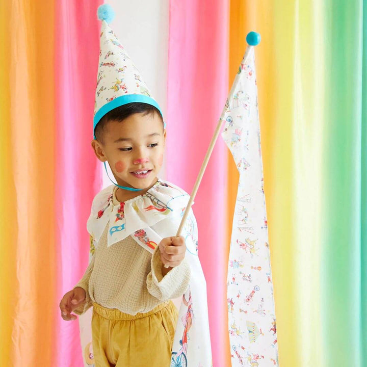 Boy wearing Sarah's Silks Silk Circus Hat, Circus Cape, and holding Circus Playsilk Wand