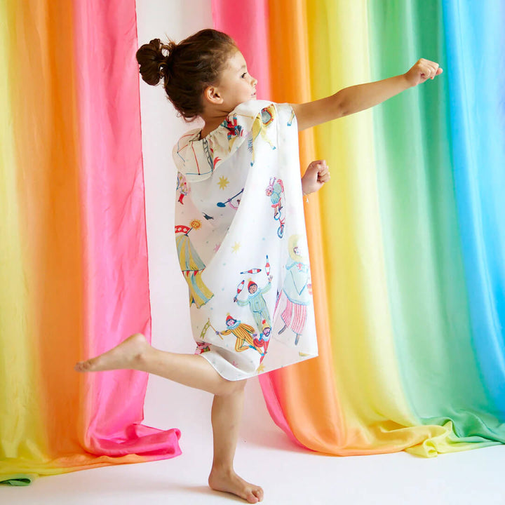 Girl marching while wearing Sarah's Silks Silk Circus Cape