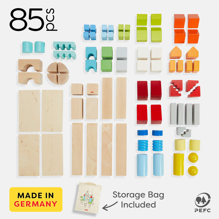 An assortment of 85 colorful wooden building blocks in various shapes, with a storage bag included, made in Germany.