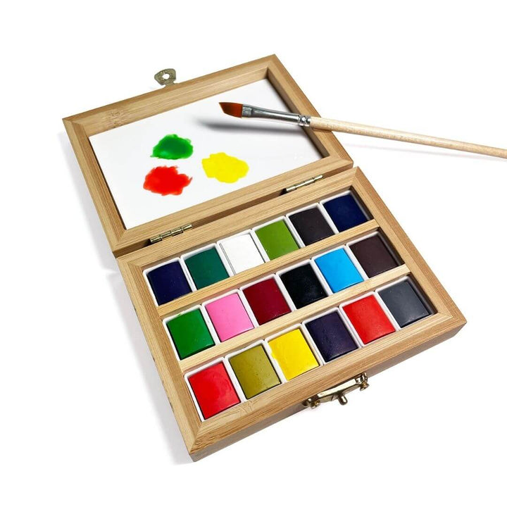 Travel Watercolor set with 3 colors and a paintbrush on the mixing tray.