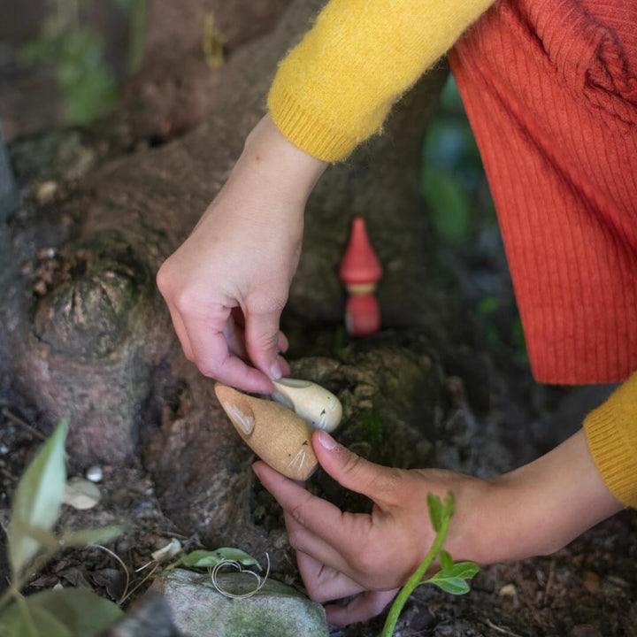 A child holds two wooden bunny figures from the 2024 Grapat Advent Calendar.