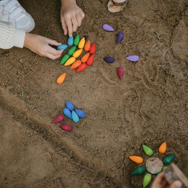 Grapat Mandala Rainbow Snowflakes with child playing in the sand