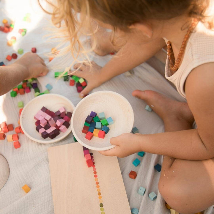 Child playing with Grapat Mis & Match colorful wooden blocks with tray