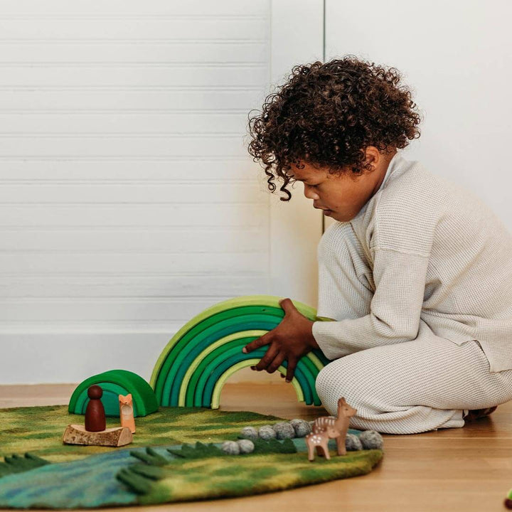 Grimm's Meadow Green Wooden Rainbow Tunnel with child playing