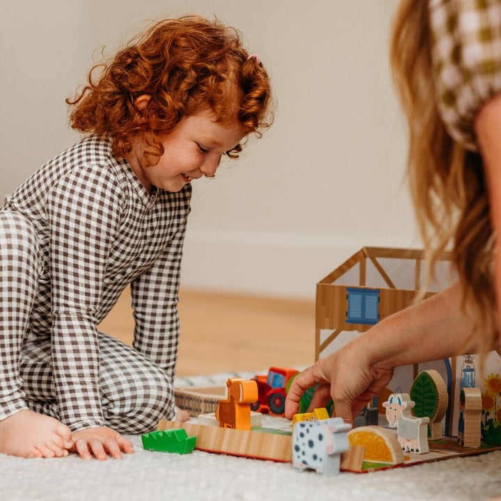 A child playing with HABA's Play World on the Farm.