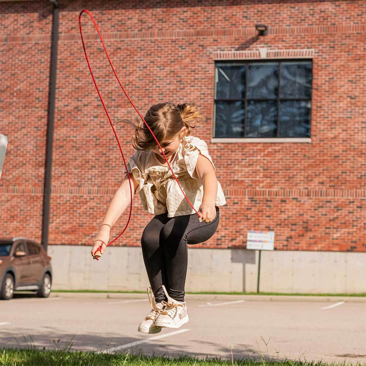 Girl skipping rope with red Huckleberry Jump Rope