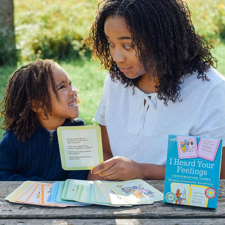 Mother and child sitting at picnic table using I Heard Your Feelings Conversation Cards