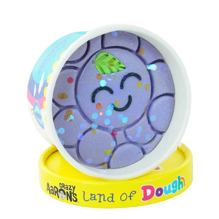 Grape Grady play dough cup from Land of Dough featuring a smiling grape bunch.