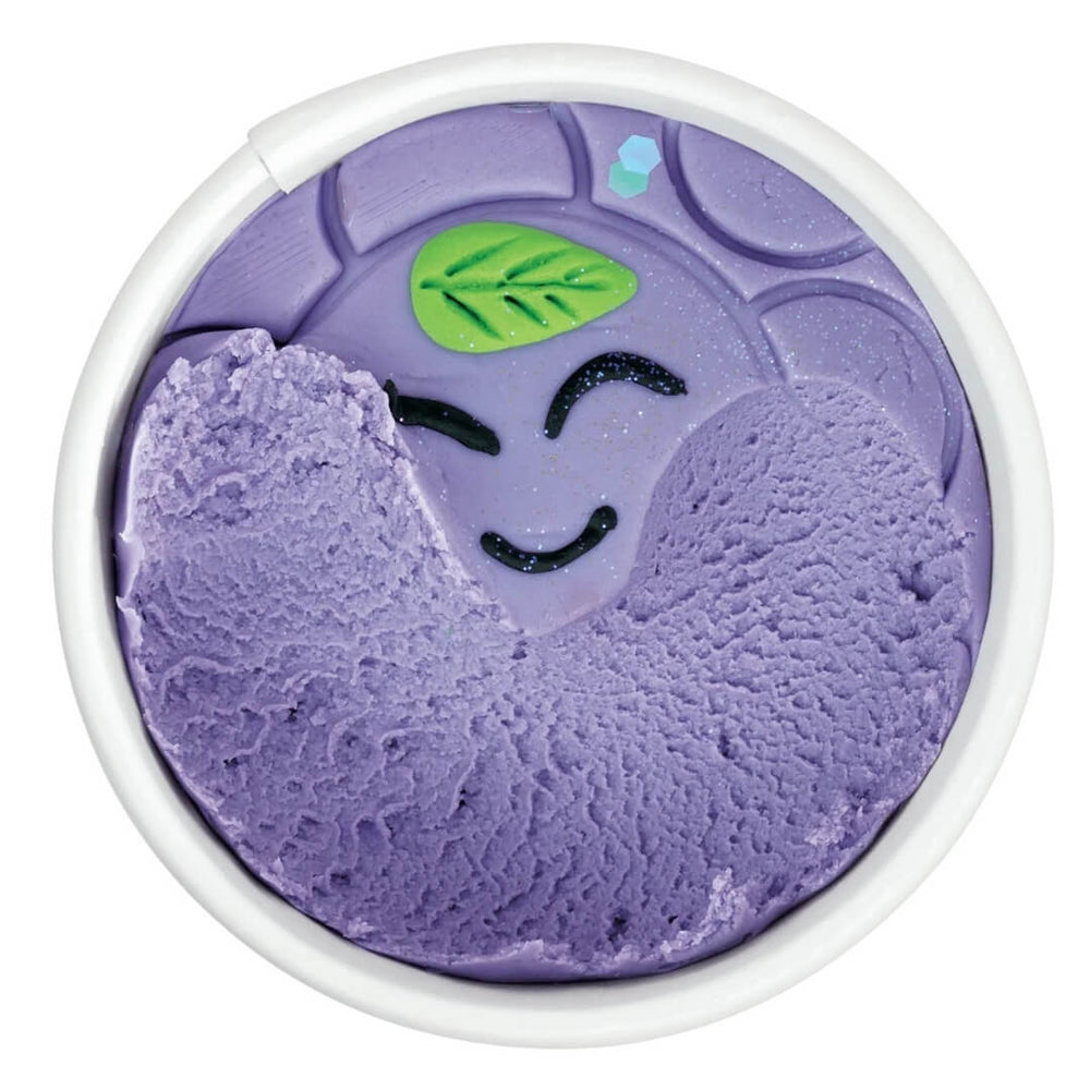 Play dough cup revealing the purple color beneath the decoration on top.