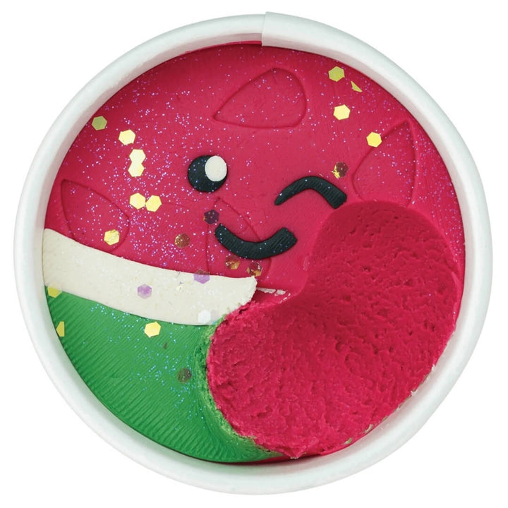 Play dough cup showing a scoop removed, revealing the red color under the top layer.