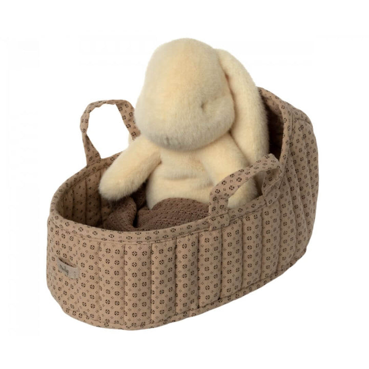 Maileg Large Carry Cot in Sand with a plush bunny inside. The soft, quilted fabric cot features handles, a cozy pillow, and a knitted blanket for cuddly companions.