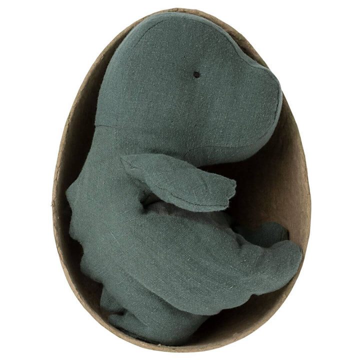 Maileg Small Gantosaurus in Egg – Dark Petrol. A soft, plush green dinosaur with a striped belly, sitting inside its matching deep green egg-shaped shell.