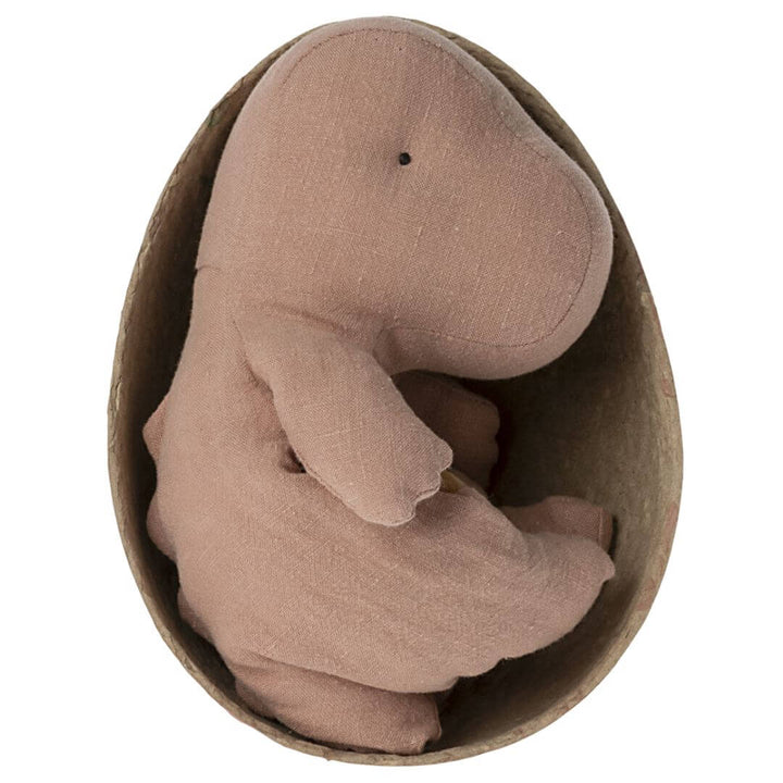 Maileg Small Gantosaurus in Egg – Old Rose. A soft, plush dinosaur toy sitting inside its matching rose-toned egg-shaped shell.