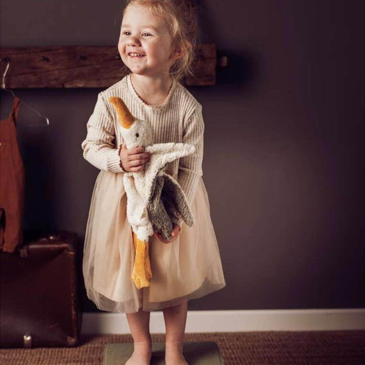 Child holding small Organic Seagull Warming Pillow