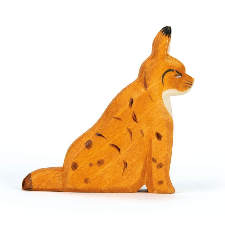 Side view of Ostheimer wooden lynx sitting figure.