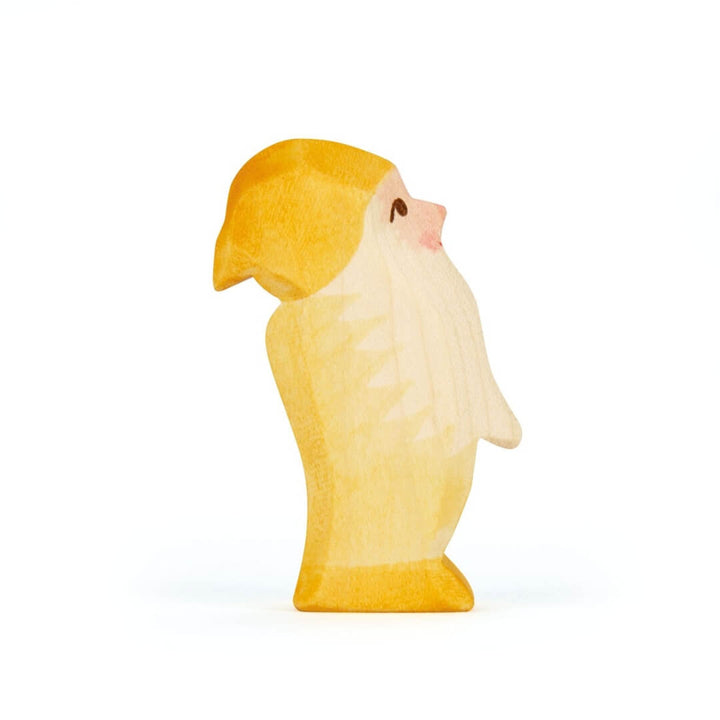 Side view of the yellow Ostheimer wooden dwarf figure.