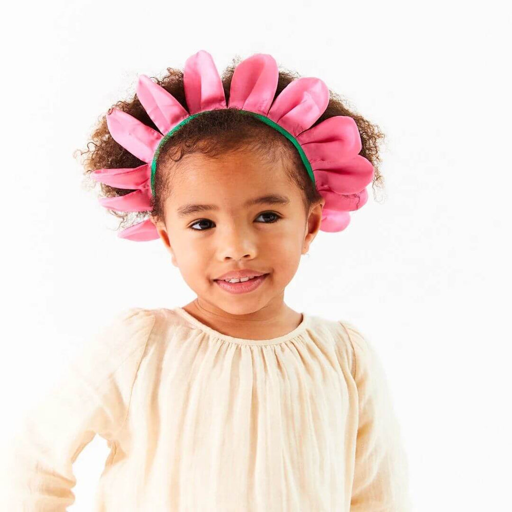 Young girl wearing the Sarah's Silks Flower Petal Crown in pink, made from 100% mulberry silk with a green elastic band, designed for Waldorf-inspired dress-up and imaginative play.