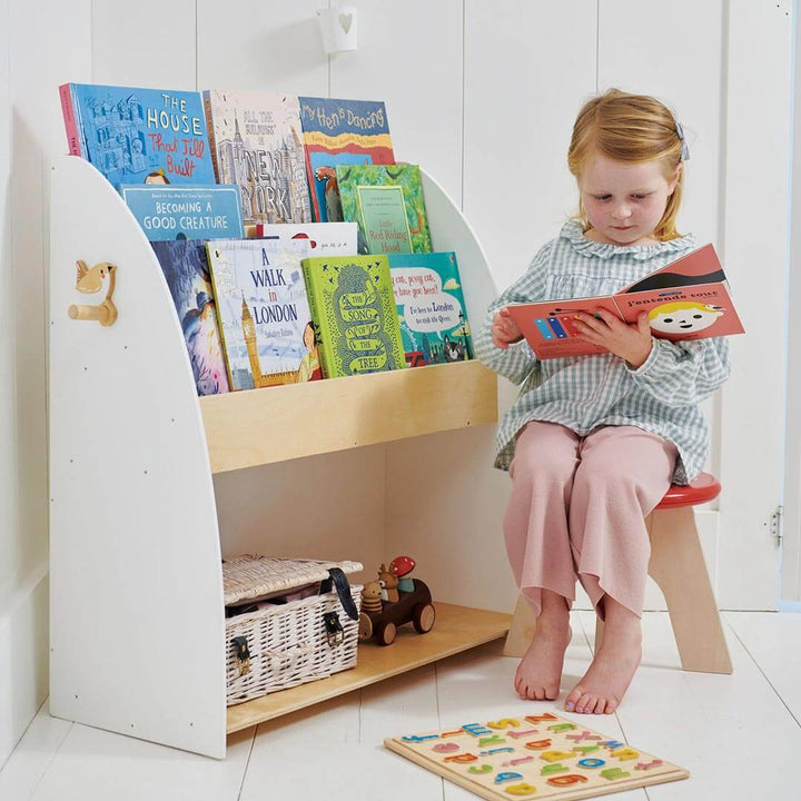 Child reading next to Tender Leaf Toys Forest Collection Wooden Book Shelf and Storage Unit