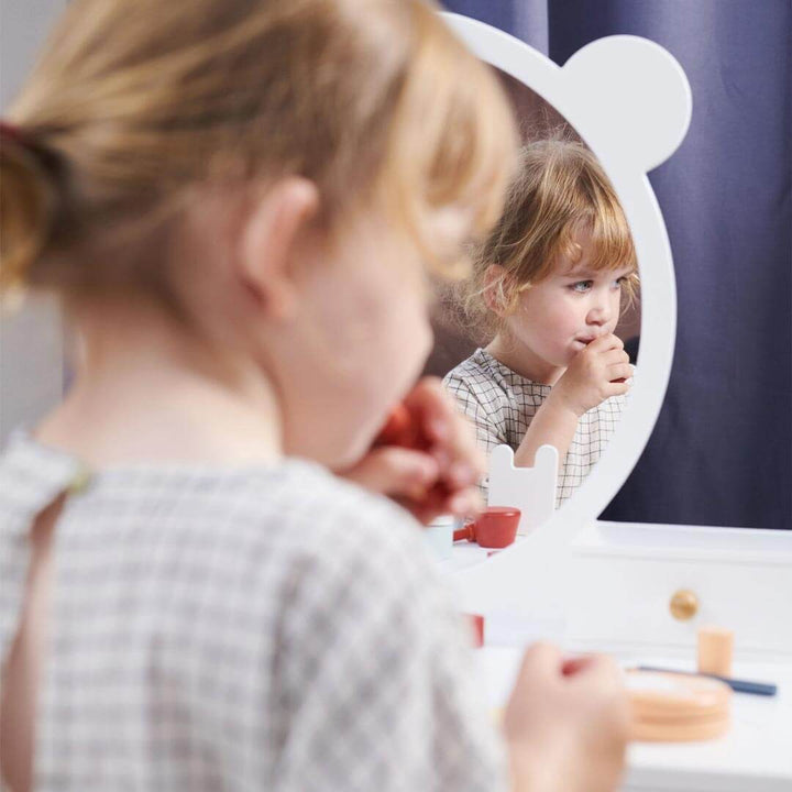 Child in mirror while sitting at Tender Leaf Toys Forest Collection Wooden Dressing Table and Stool