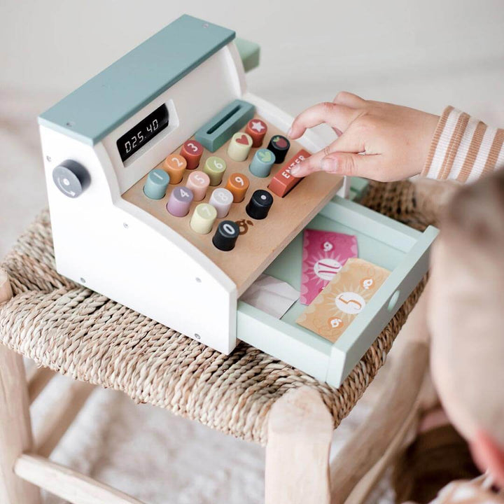 Kid pressing button on Tender Leaf Toys Wooden General Store Cash Register