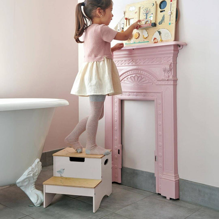 Girl standing on Tender Leaf Toys Wooden Steps with Storage