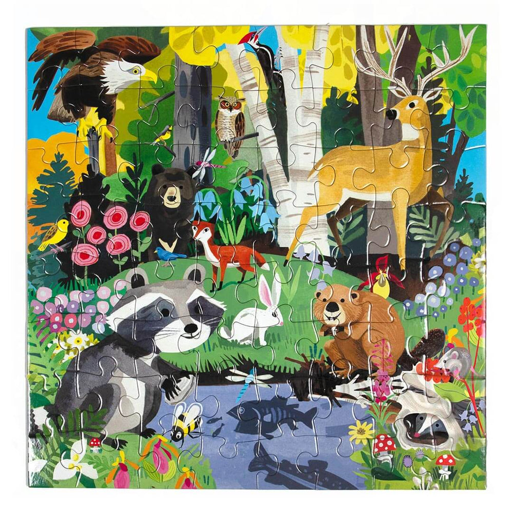 64 Piece Woodland Jigsaw Puzzle with illustrated woodland scene with a deer, raccoon, beaver, pond, bunny, fox, bear, eagle, owl, trees, and more