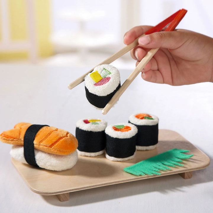 HABA Biofino Susi Set- Play food and imaginative play- Child using chopsticks to pickup toy sushi- Bella Luna Toys