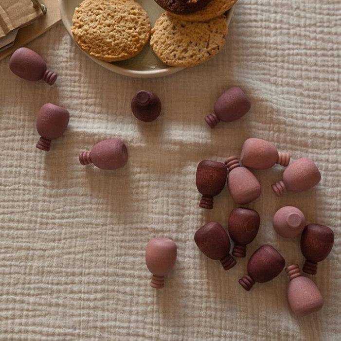 A handful of Grapat Wooden Mandala Pineapples scattered on a table