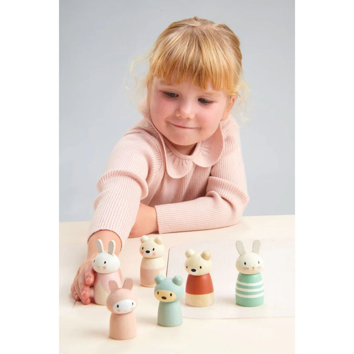 Tender Leaf Toys- Child playing with wooden bunnies and bears on a table- Bella Luna Toys