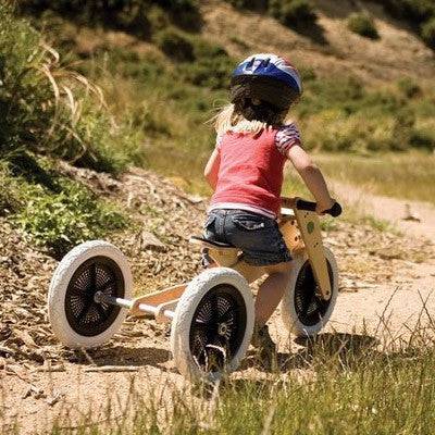 Child riding Wishbone bike outdoors